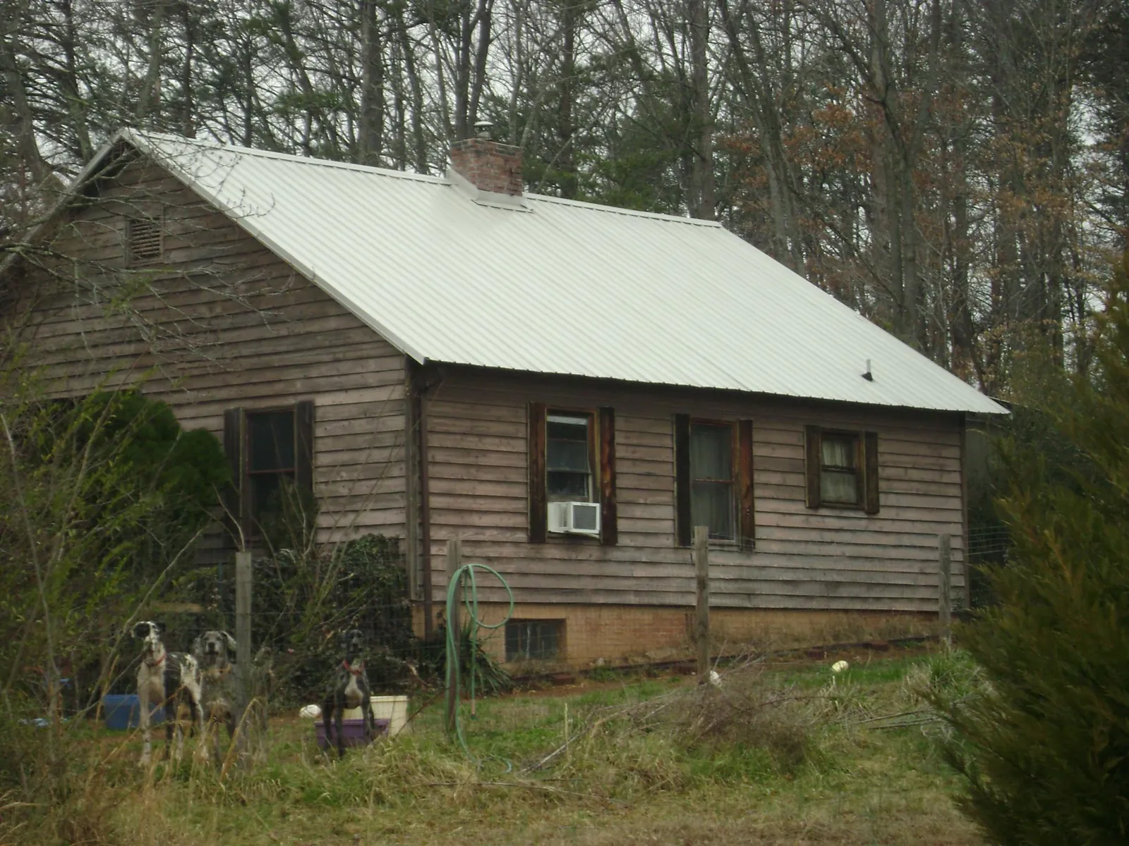 White metal roof on an old wood sided farmhouse, from a Metal Roof Installation job in Cortland